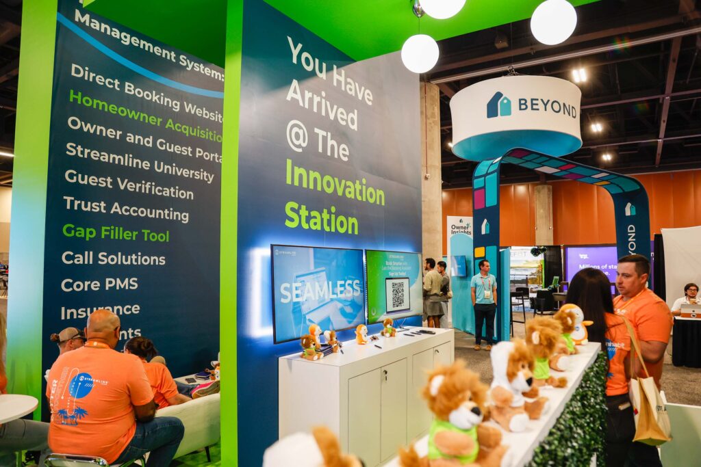Streamline's Innovation Station booth at VRMA International 2024, with lion plush toys and product demo screens