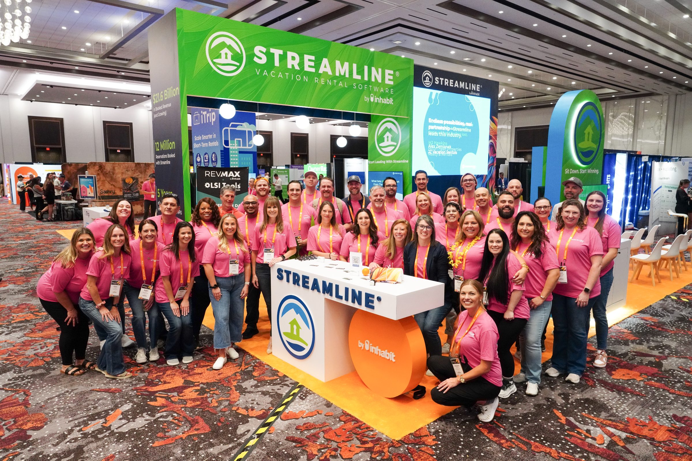 Team members smiling at a booth